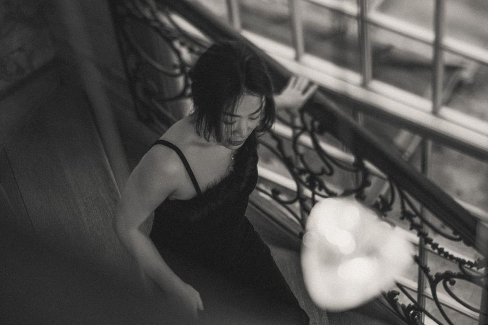 Sequence of dreamy black and white photographs showing movement and light through window blinds.