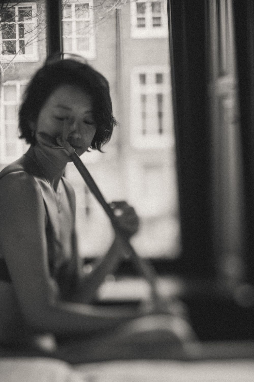 Artistic black and white photo sequence showing a person sitting by a window.