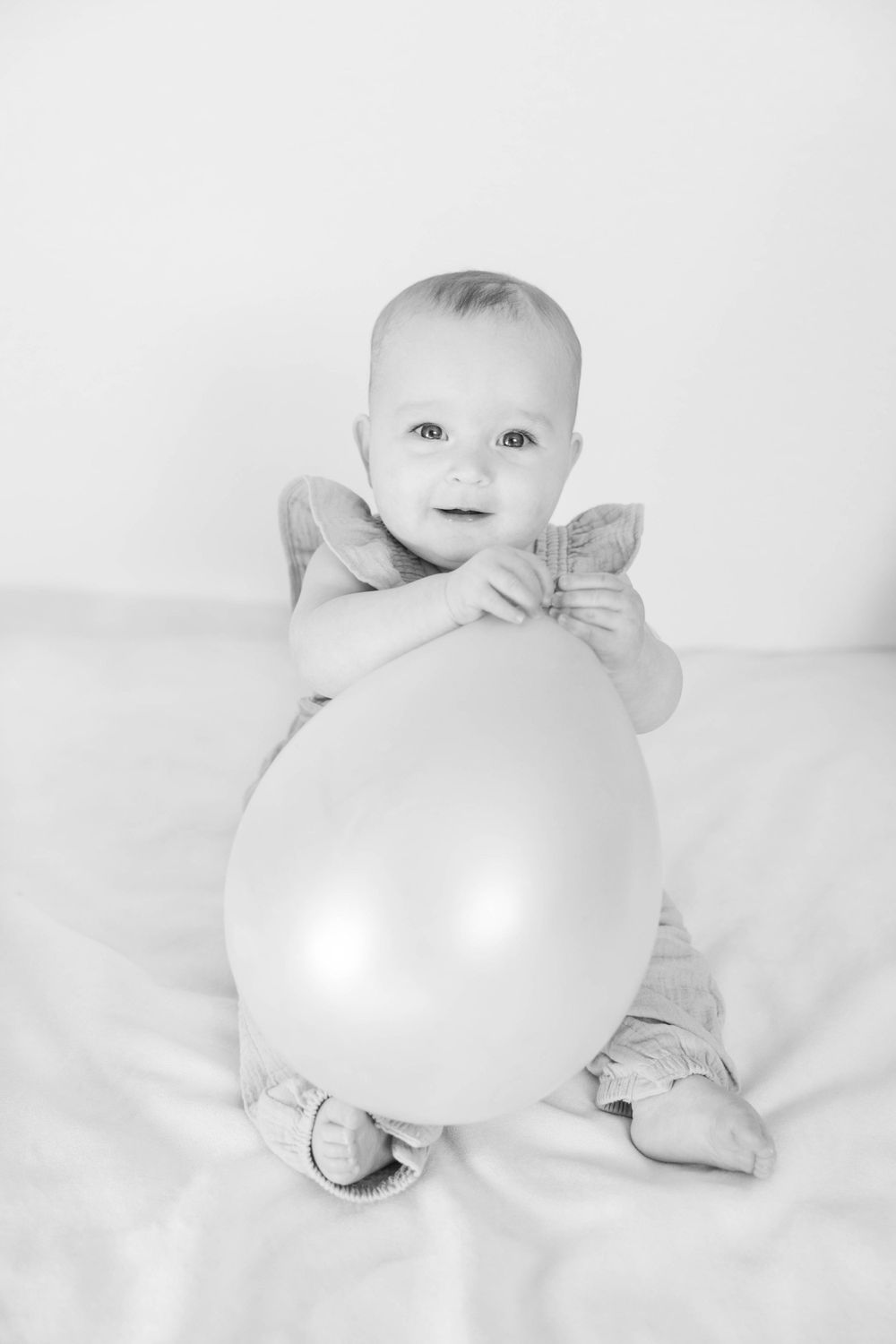 Black and white baby photograph with balloon.