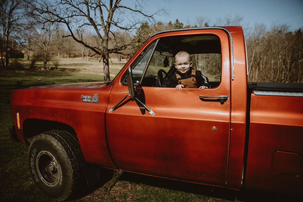 A series of connected photos showing different angles of a vintage red pickup truck parked outdoors.