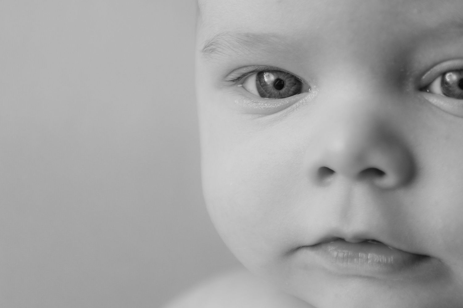 A series of close-up black and white portraits showing different facial expressions and emotions.