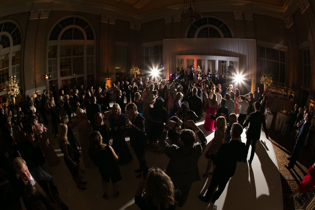 Elegant ballroom filled with guests dancing at a formal evening gala event with dramatic lighting at Union Station in Dallas, TX