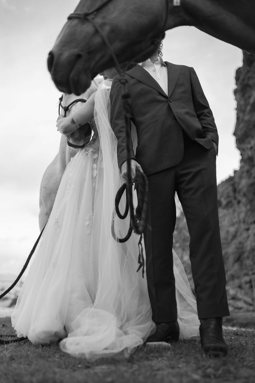 A sequence of black and white wedding photos showing the couple's feet and dress hem while walking outdoors.