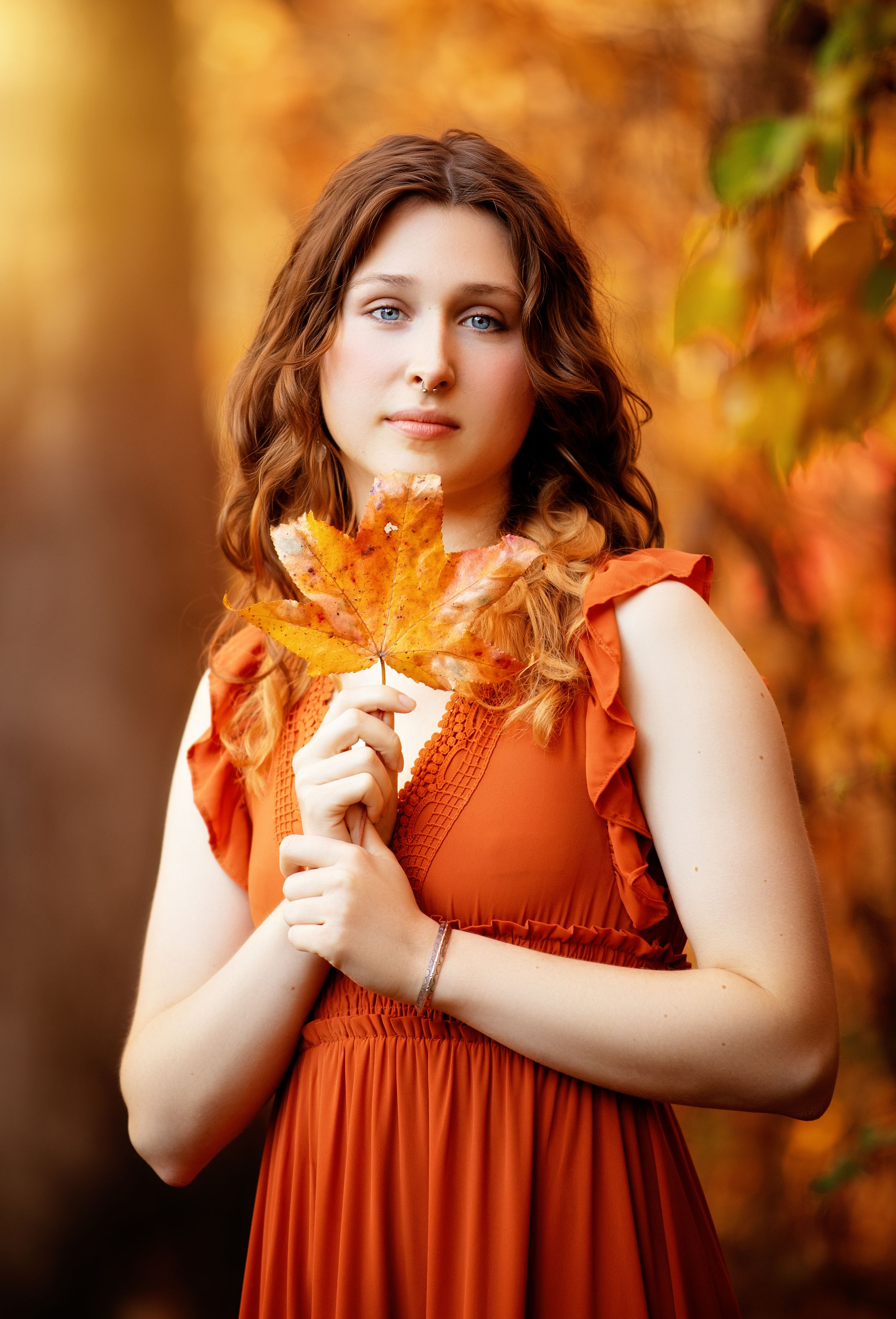 A sequence of autumn-themed photos showing someone in a rust-colored dress holding a maple leaf against a warm bokeh background.