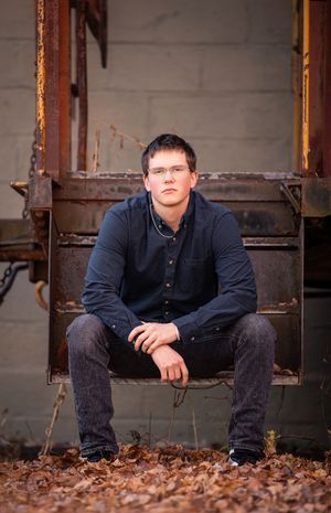 A series of three casual outdoor portraits showing someone in a navy jacket sitting against a rustic metal backdrop.