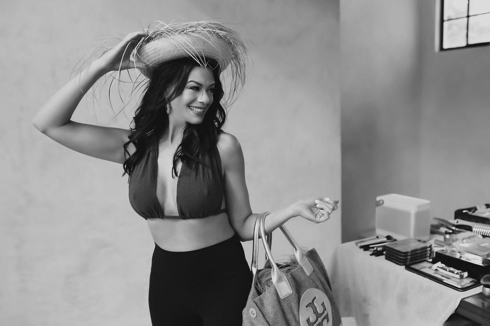A person in a black tank top dances and poses expressively in a series of black and white photographs.