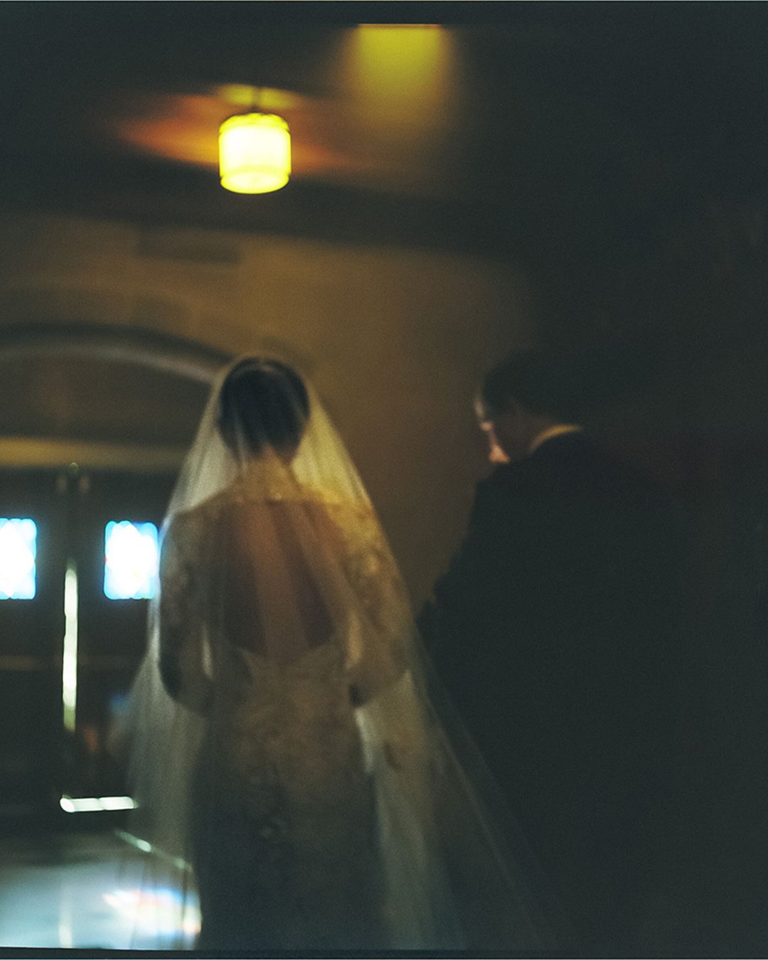 Dimly lit indoor event space with soft yellow lighting creating a moody ambiance.