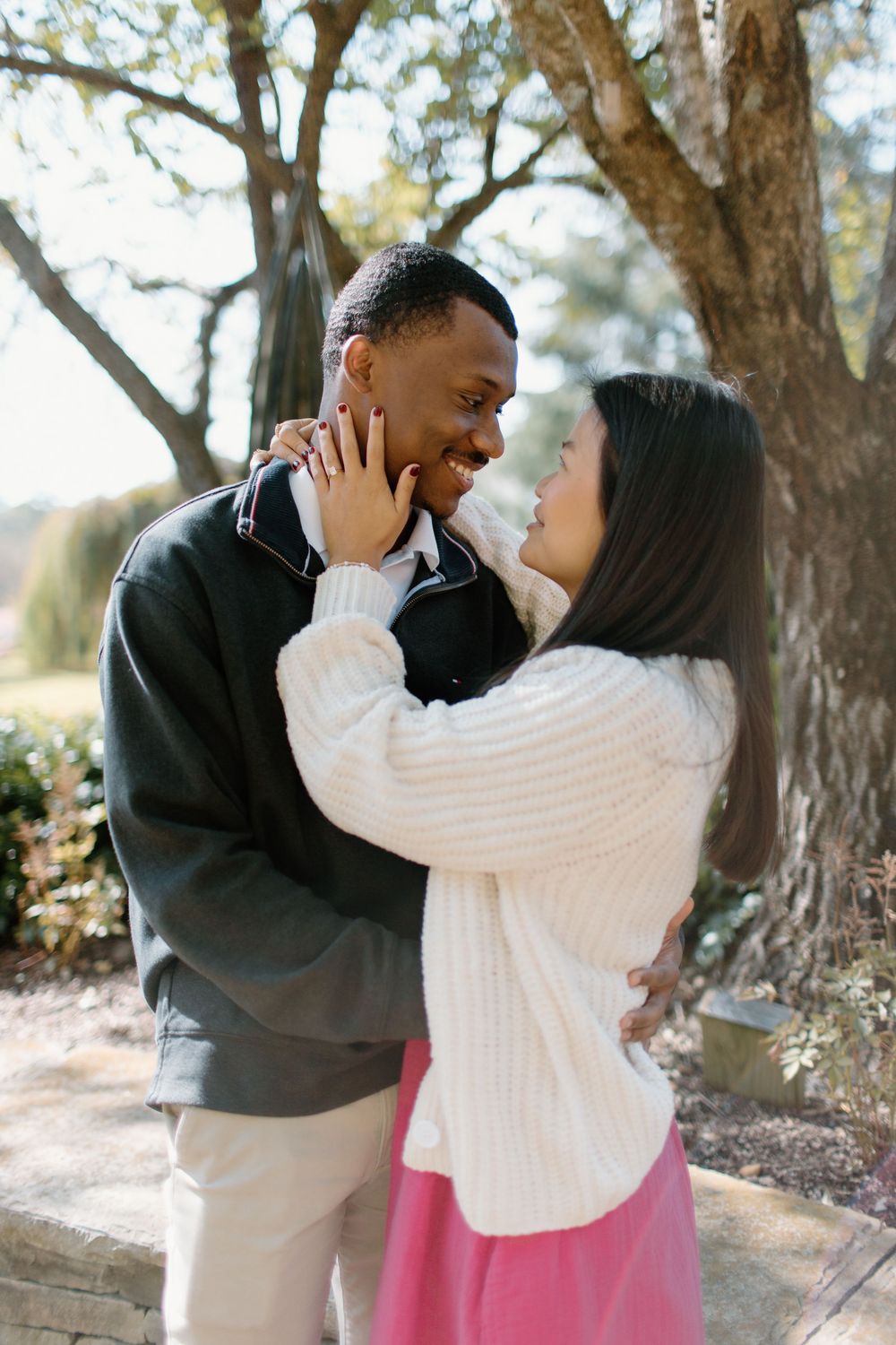 Couple in casual winter wear sharing playful moments outdoors.