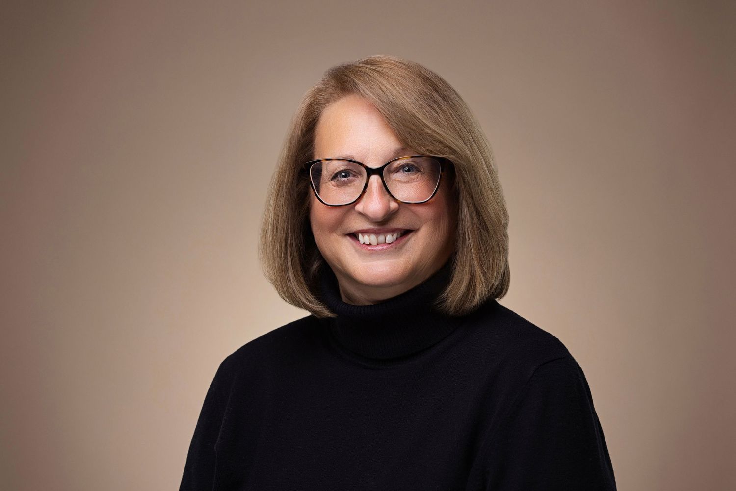 Professional headshot series showing a person in a black turtleneck and glasses against a neutral background.