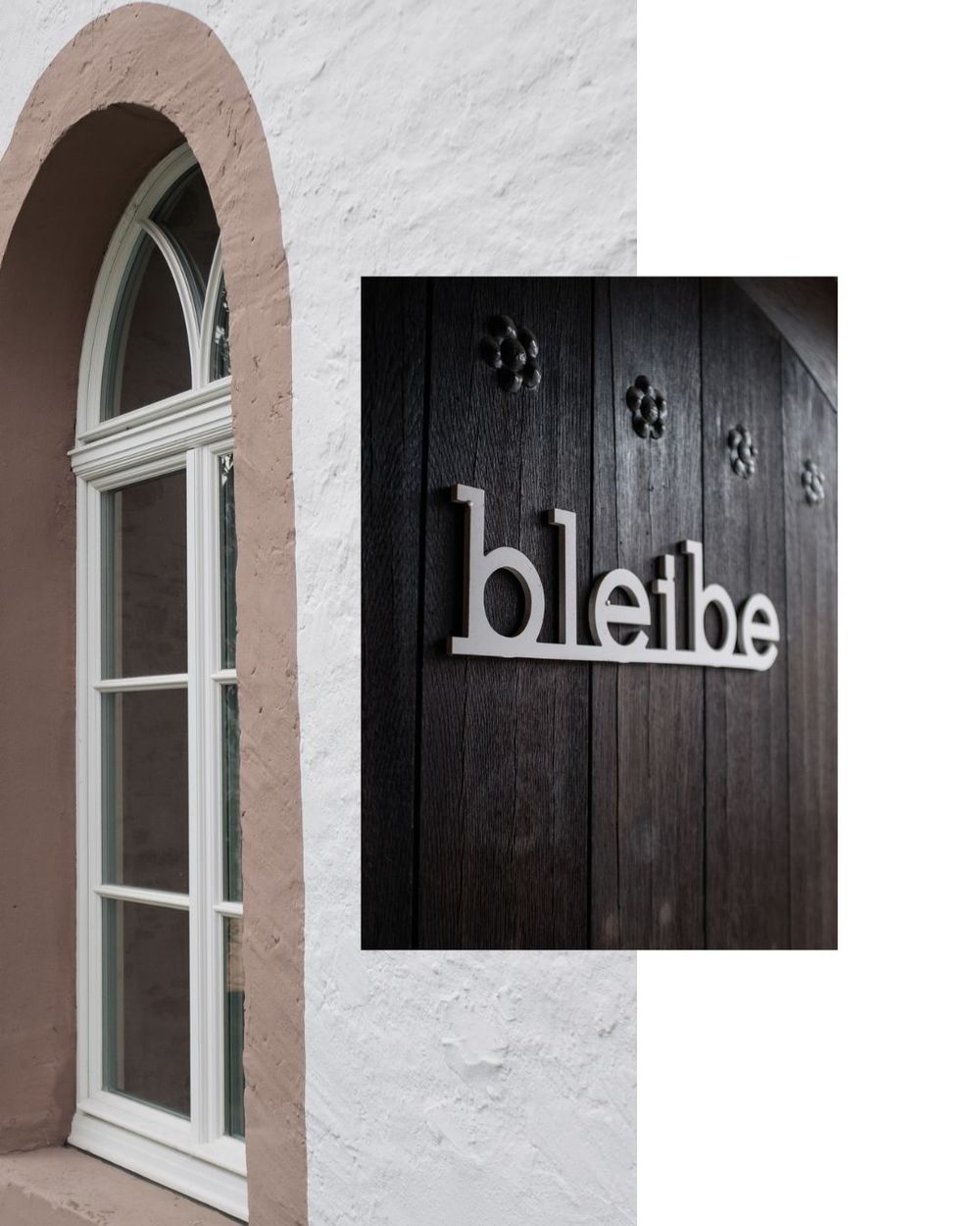 Modern white arched doorway and dark wood wall with 'bleibe' text signage in minimalist design.