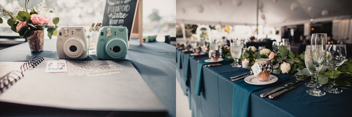 Elegant wedding reception tent with navy blue table runners, floral centerpieces, and Instax cameras on a guest book table.