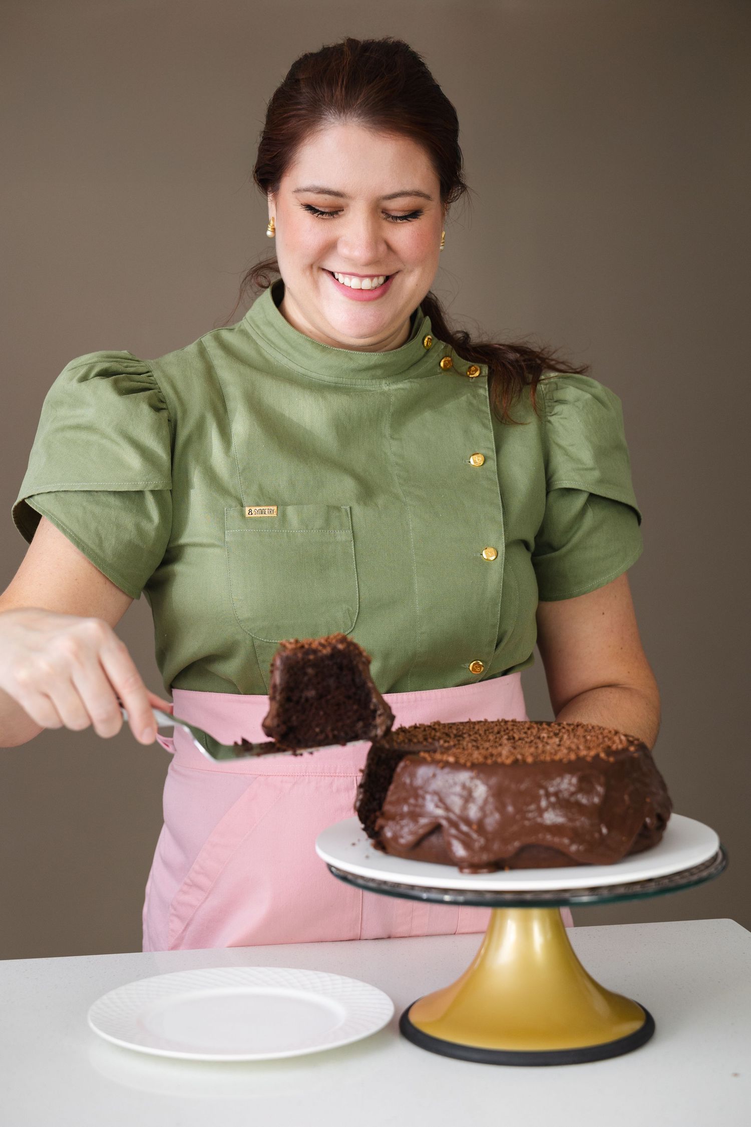 A sequence of images showing someone in a green top assembling and frosting a chocolate dome cake on a plate.
