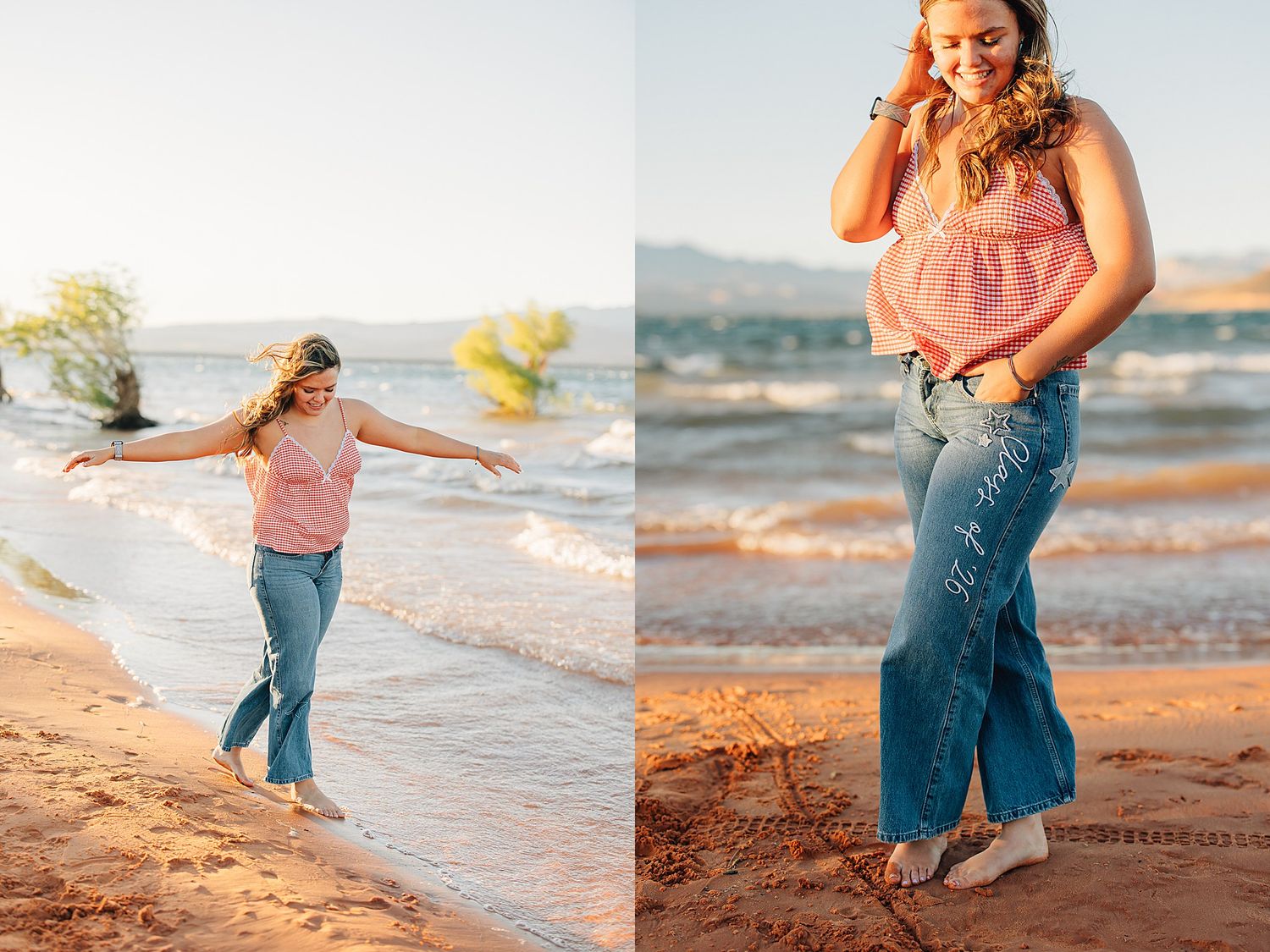 Young woman in pink top and wide-leg jeans poses playfully on a sandy beach at golden hour.