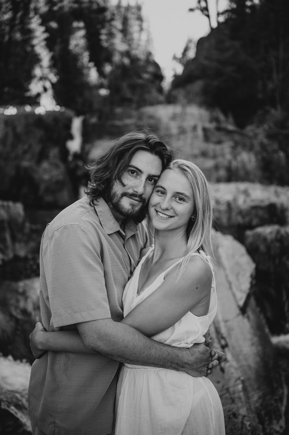 Couple adventure photoshoot session at Myra Falls on Vancouver island taken by professional photographer of couple portrait smiling