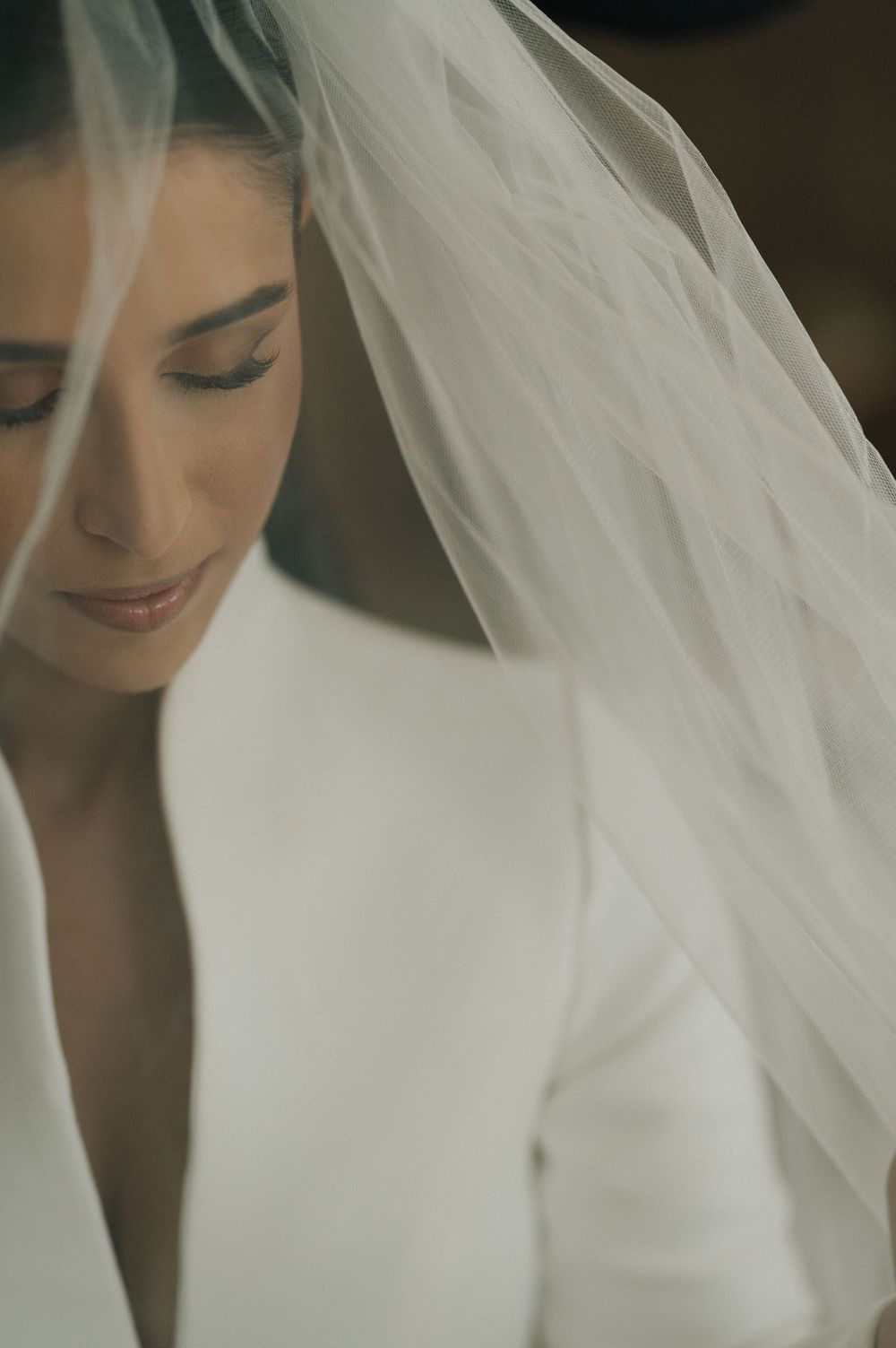 Close-up shots of a bride wearing an elegant white wedding dress and flowing veil.
