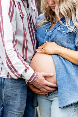 Close-up shots of a couple wearing denim and striped clothing embracing outdoors.