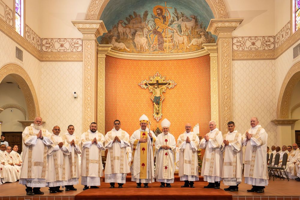Newly ordained deacons posing at the altar with current and former bishops at Saint Augustine Cathedral, by N&D Media Production.