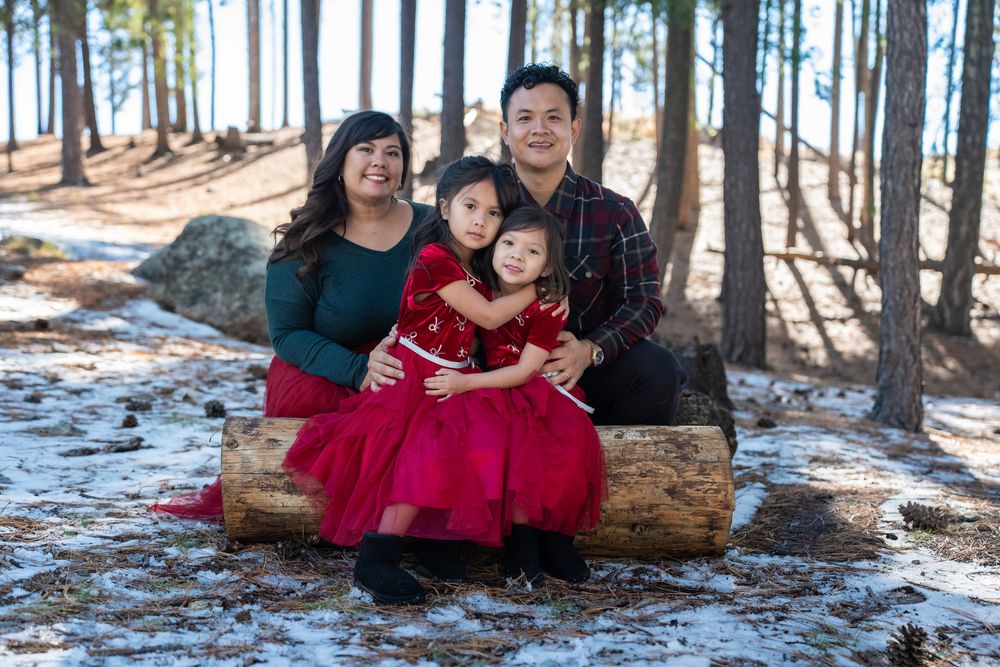 Snowy winter family portrait of parents and daughters sitting together on Mount Lemmon near Tucson, captured by N&D Media.
