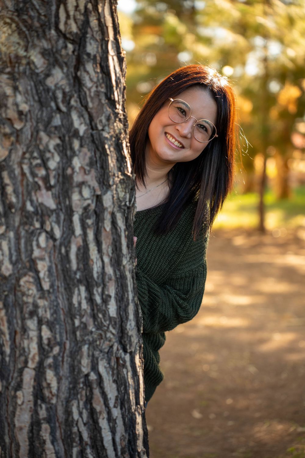 Warm golden hour fall portrait of a woman posing in a Phoenix, Arizona pumpkin patch, captured by N&D Media Production.