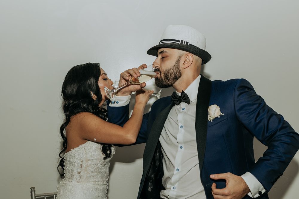 Wedding couple shares a drink together in a romantic moment during their reception celebration at Babylon Palace.
