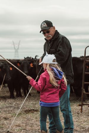 Teaching moment at cattle ranch with traditional ranching tools.