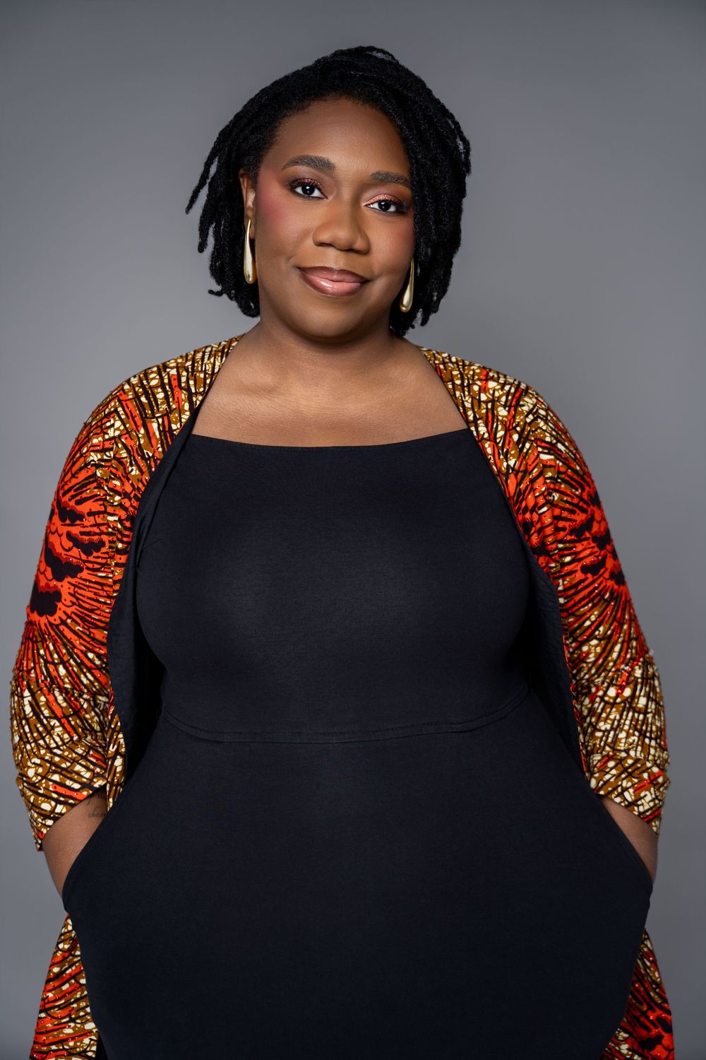 A series of fashion portraits featuring a black dress with vibrant orange and gold patterned statement sleeves.