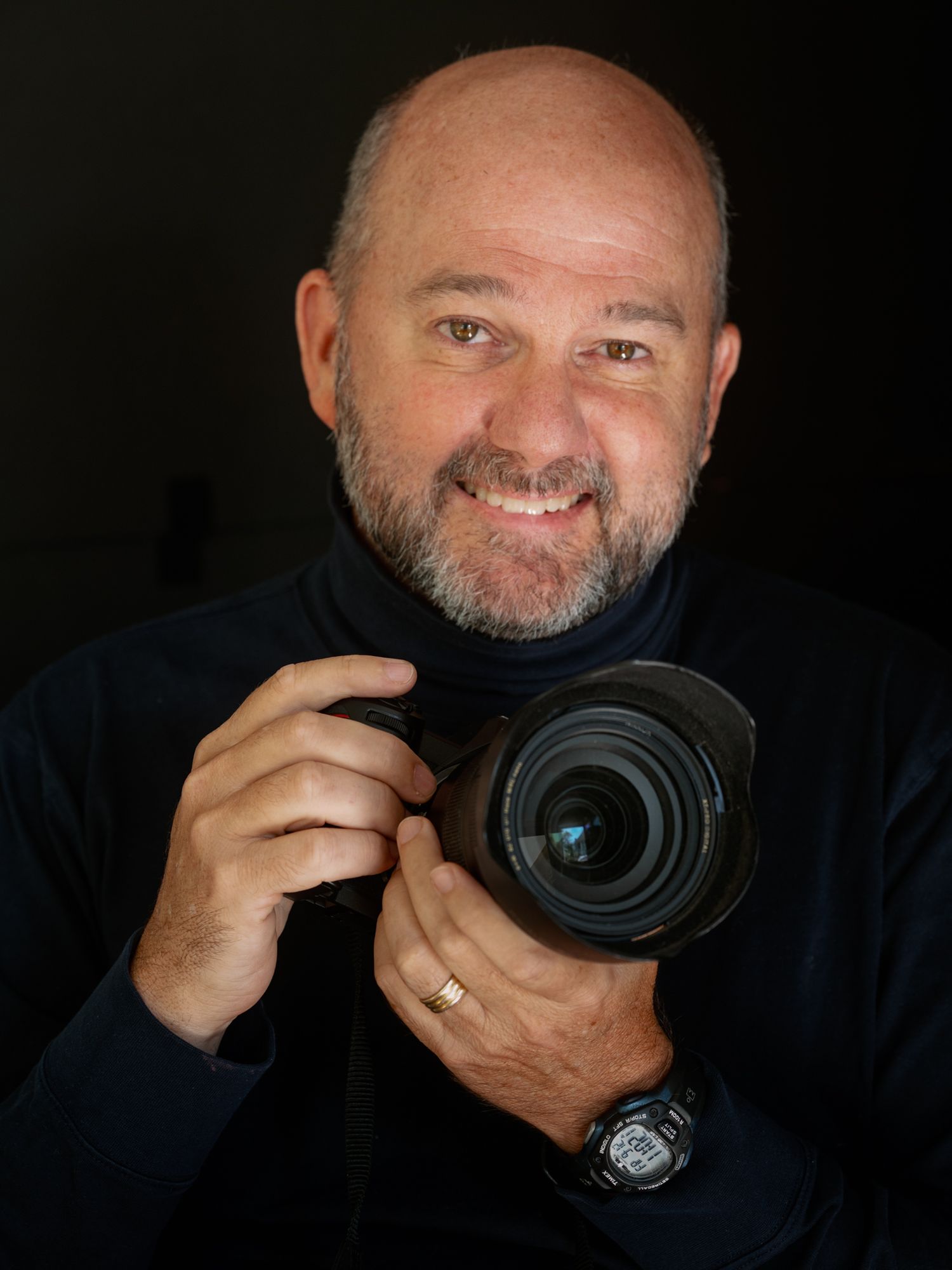 Portrait of man in navy turtleneck sweater against blurred background captured by Tom McCall Photography on the Eastern Shore of MD