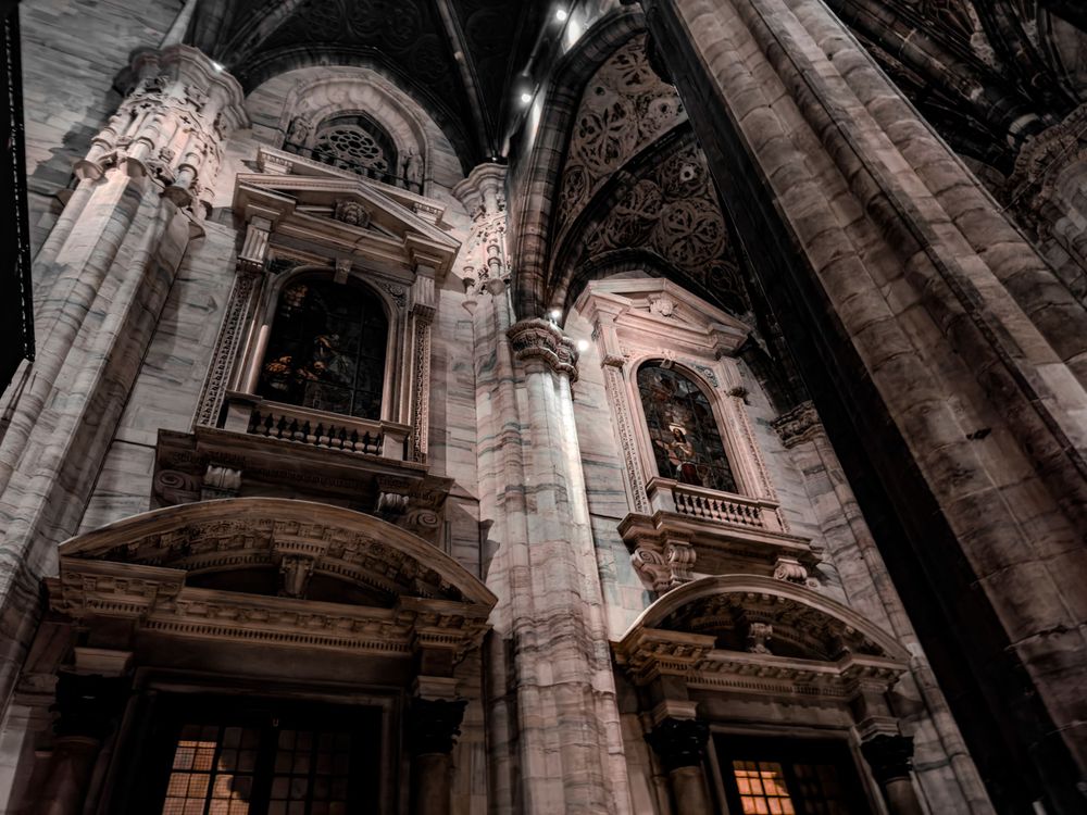 Baroque architectural details inside cathedral showing ornate stone carvings and arched windows.