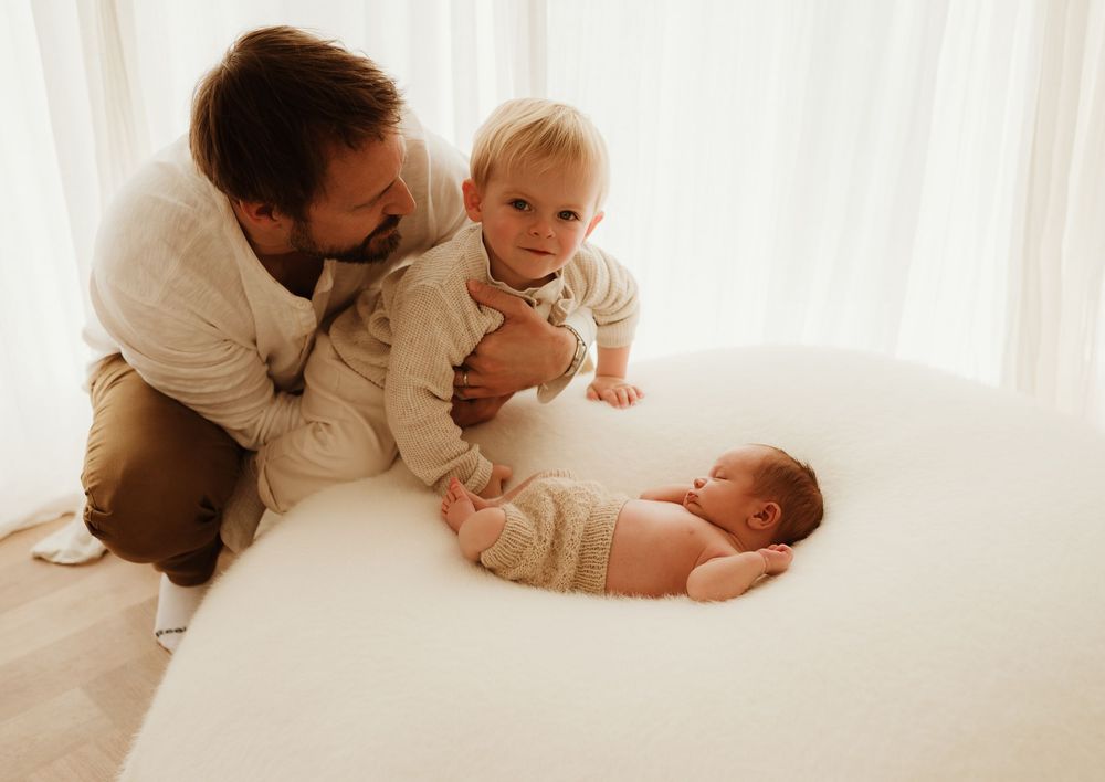 Family members share tender moments together in a series of white-toned lifestyle photographs.