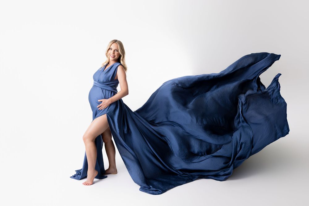 a fabulous dress toss during a maternity studio photo session in cedar Park tx
