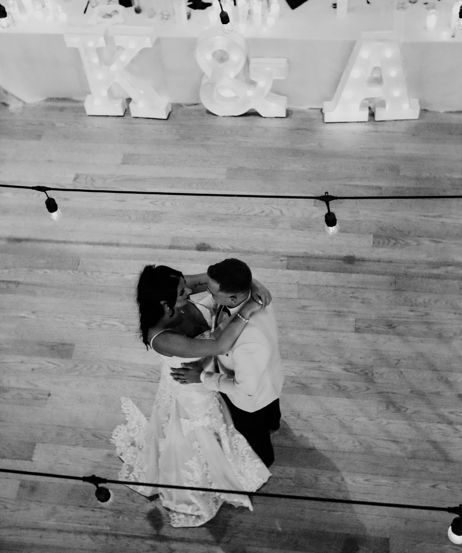 Black welcome sign and registration table display for Ashleigh and Kevin's wedding at City Hall features romantic quote and white cloth.
