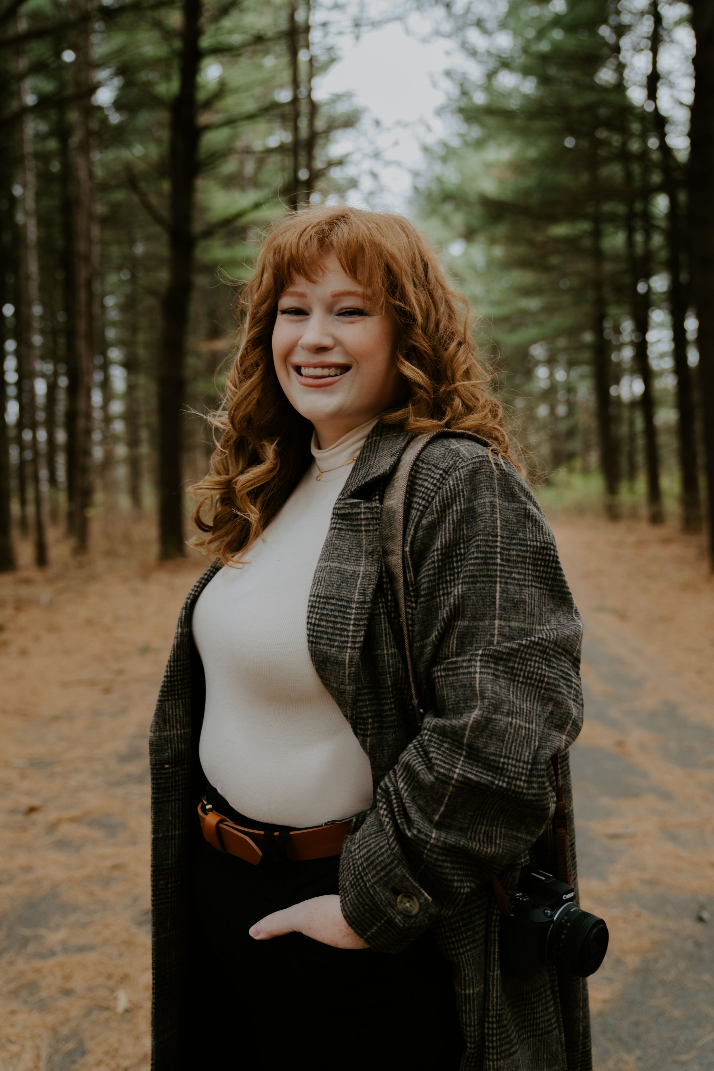 Candid moments captured in a forest setting with natural lighting and pine trees in the background.