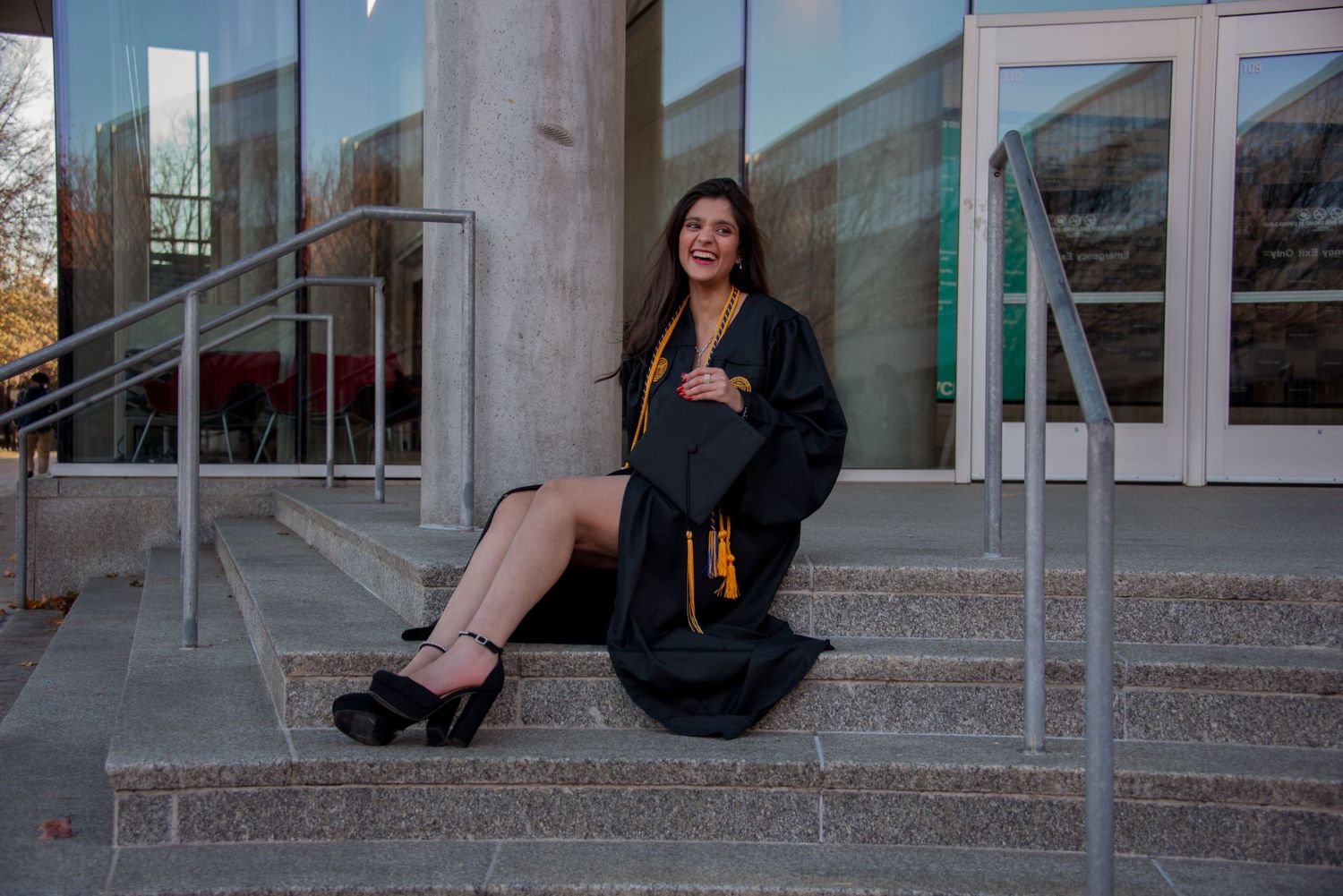 VCU graduate photo on stairs smiling