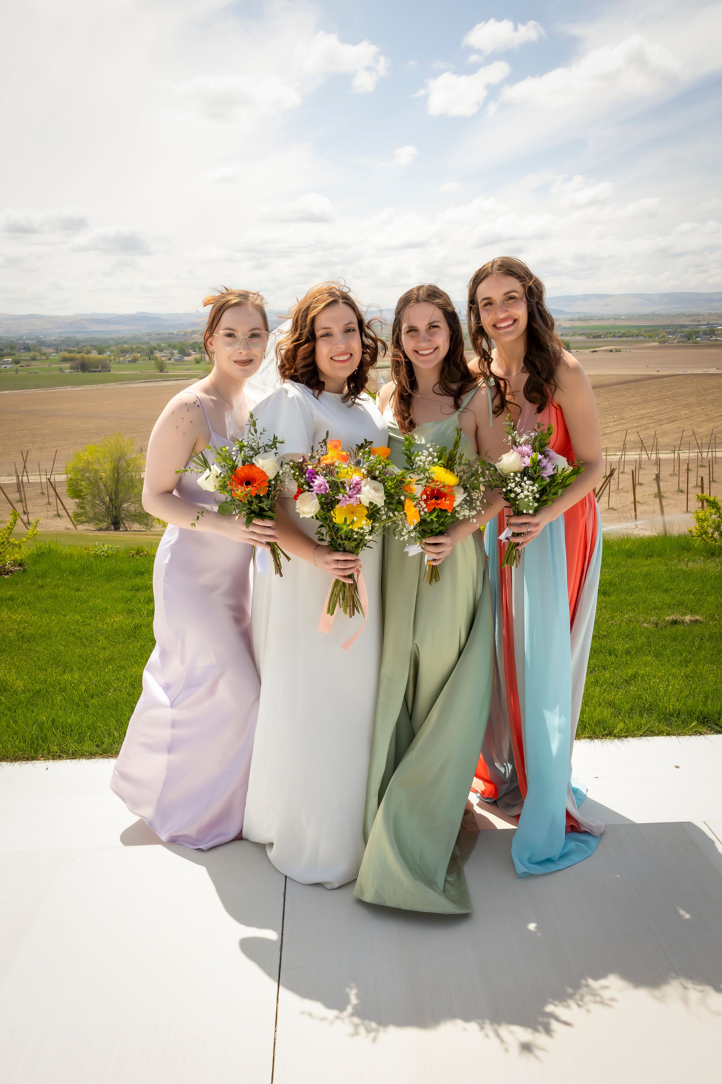 bride and bridesmaids wearing spring colors at Garman Hill Wilder, Idaho