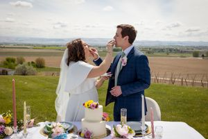 bride and groom feeding cake to each other at Garman Hill Wilder, Idaho