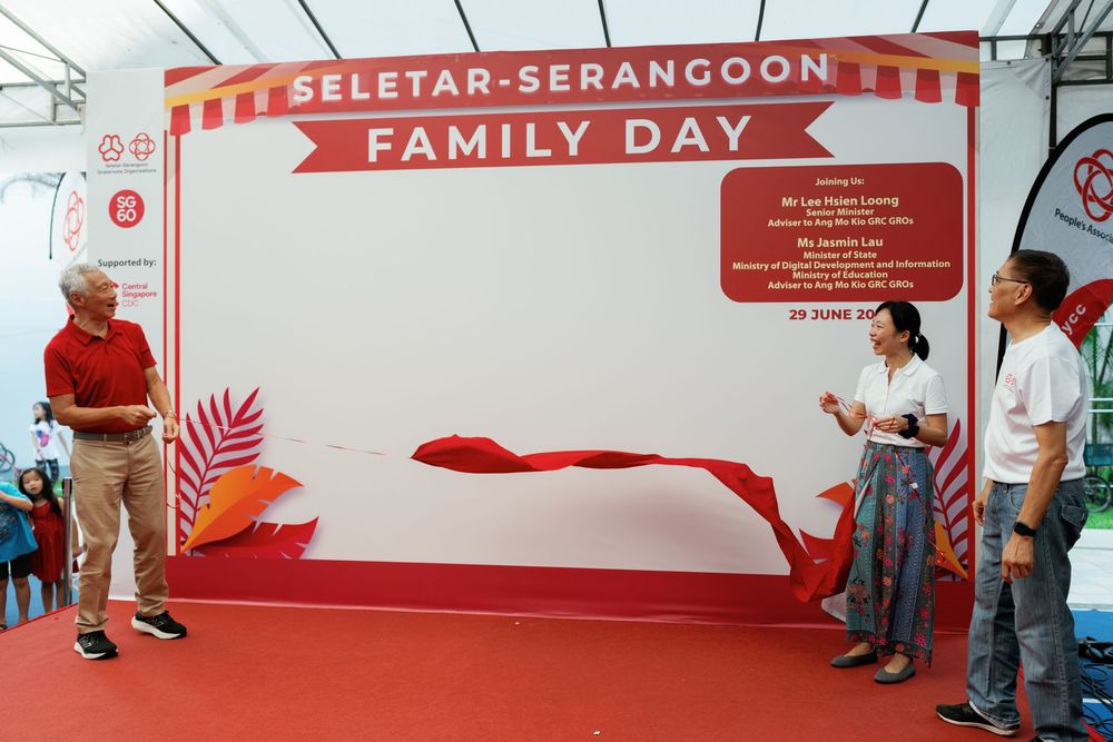 Long red banner with text reading 'Family Day' hangs across the top of a community event space.