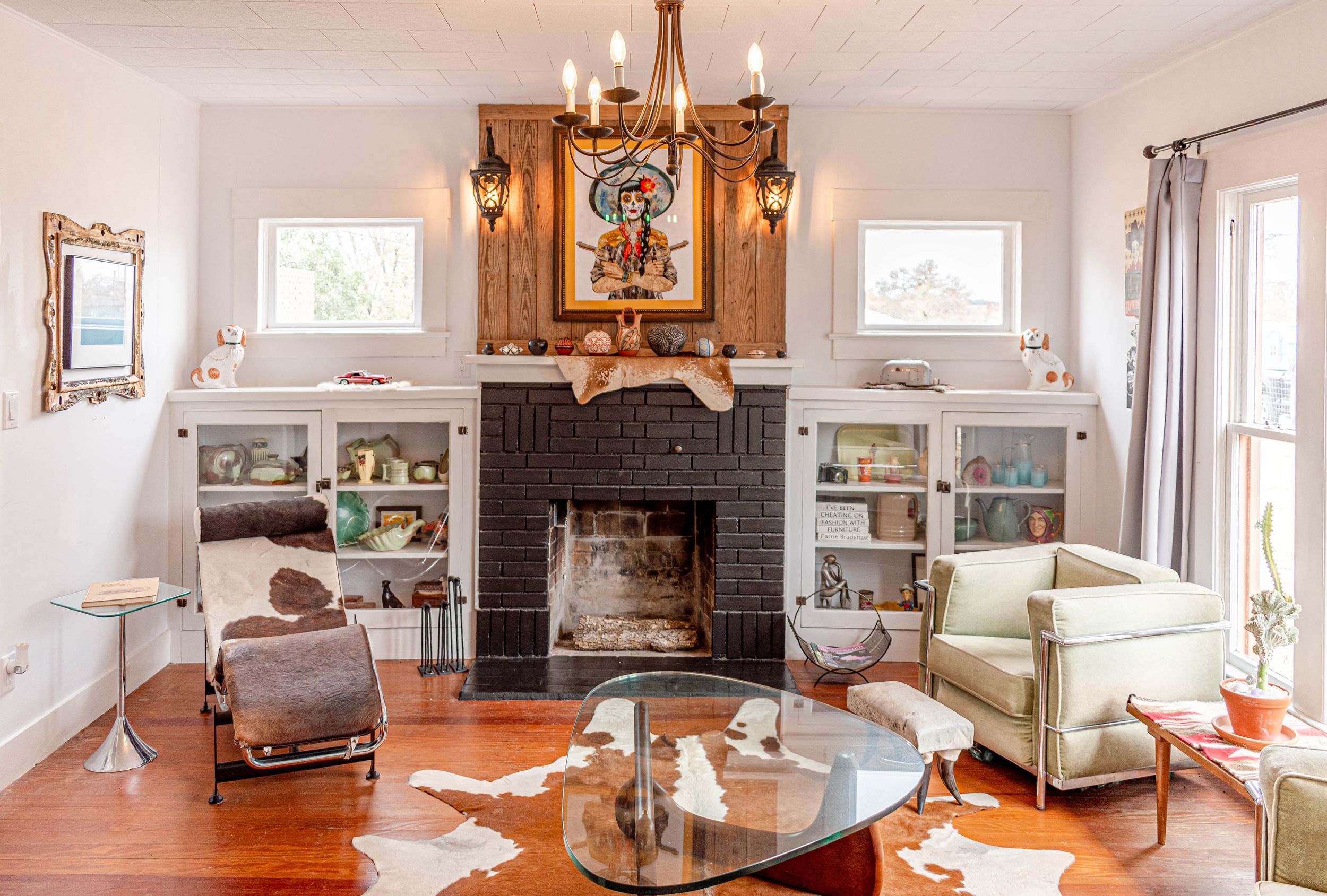 Spacious living area featuring hardwood floors, fireplace, and traditional furnishings in warm tones.