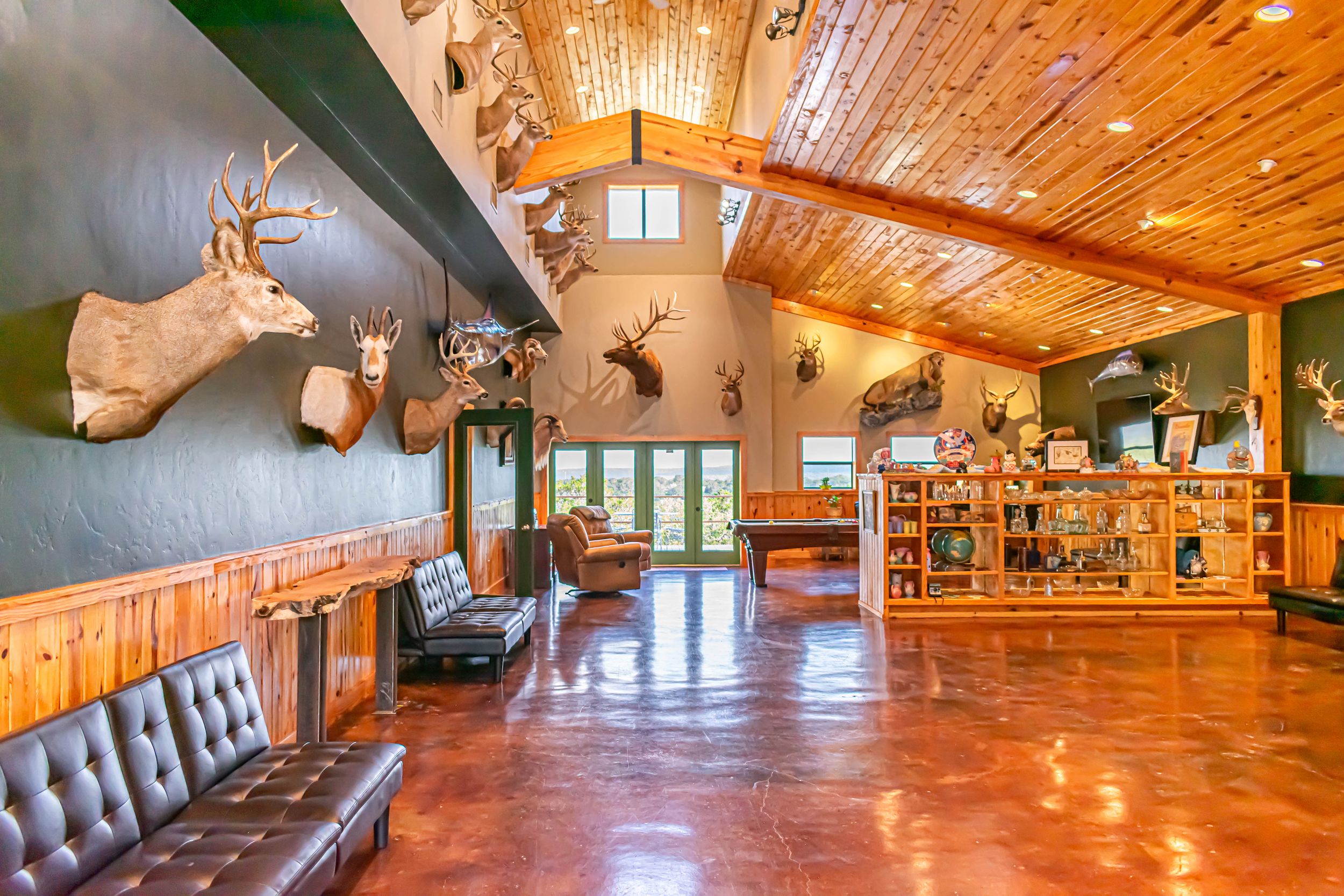 Large event space with wooden ceiling, polished floors and rustic decor spanning the length of the room.