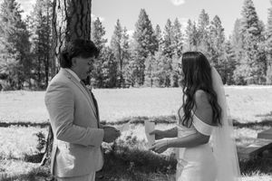 A romantic black and white winter photo sequence shows a couple dancing and twirling together in the snowy forest.