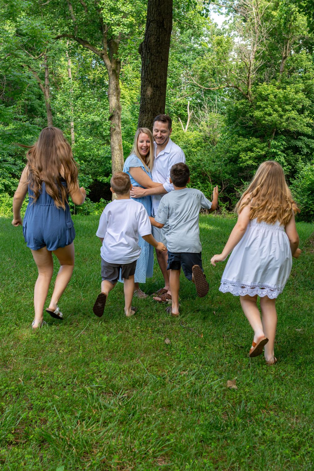 A sequence of playful poses on a grassy hill showing movement and joy in a natural outdoor setting.