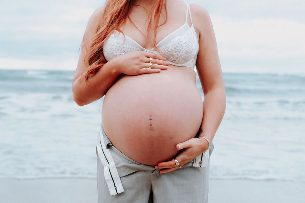 Maternity photoshoot showing close-up details of white lace dress on beach.
Altona Family Photographer Melbourne