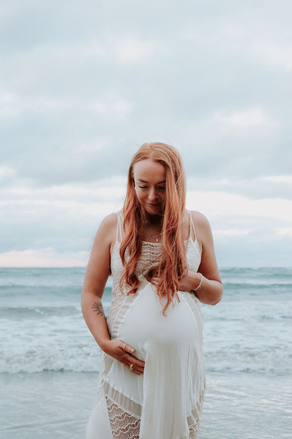 Person in white lace dress posing gracefully by the ocean.
Altona Family Photographer Melbourne