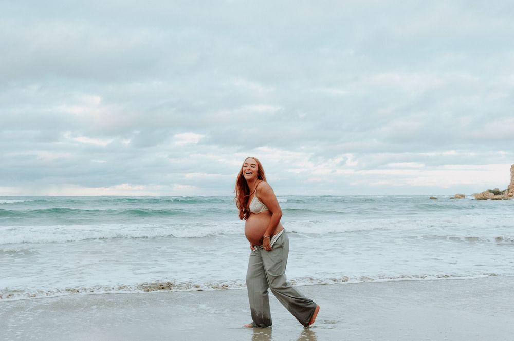 Maternity Photoshoot, Pregnant woman playing in ocean waves near cliffs at sunset.
Altona Family Photographer Melbourne