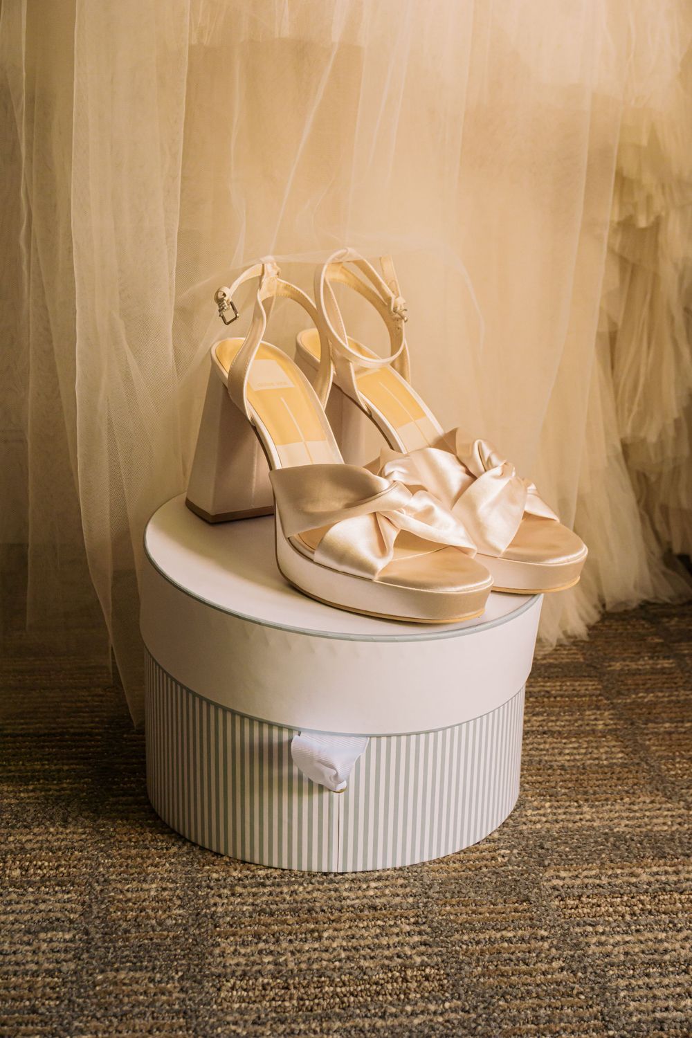 Colorado Springs Wedding Photographer. Photo of the bride's shoes displayed in front of her dress.