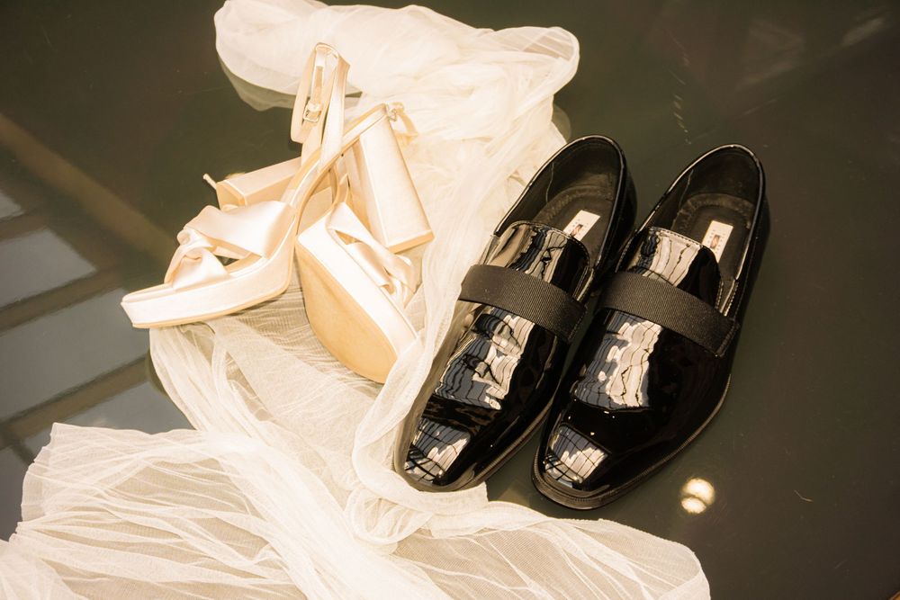Colorado Springs Wedding Photographer. Photo of the bride and groom's shoes and veil displayed.