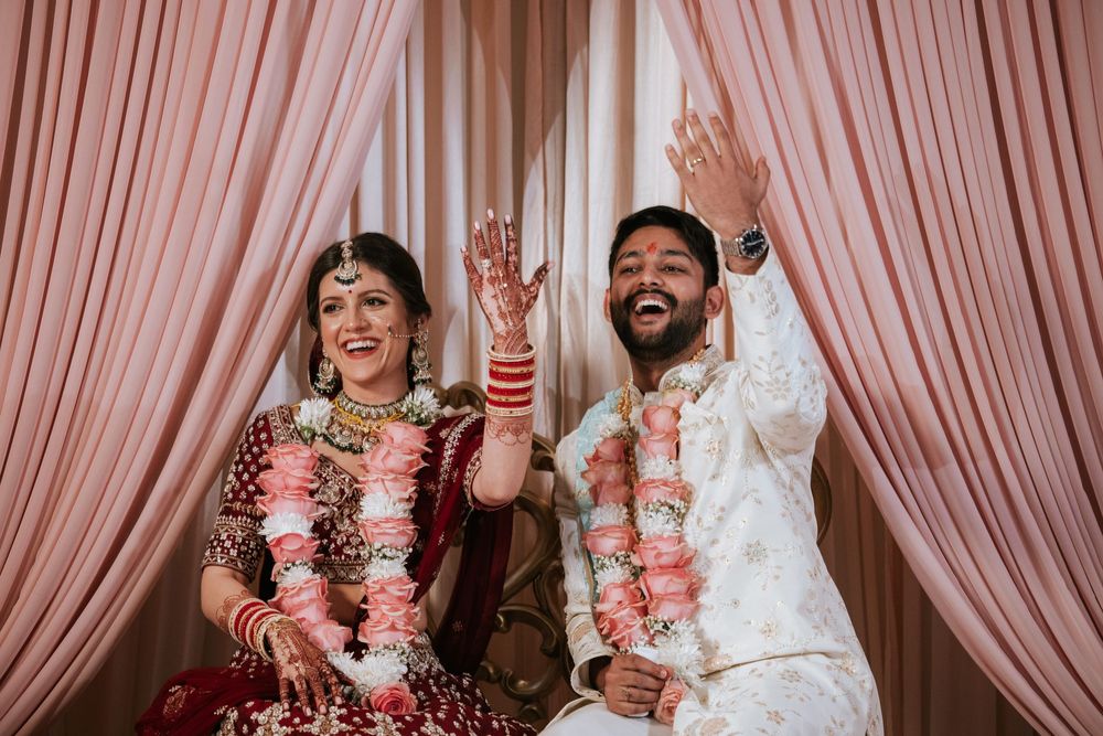 Bride and groom share a joyful moment during their Indian wedding ceremony at Richmond Marriott in vibrant traditional attire.