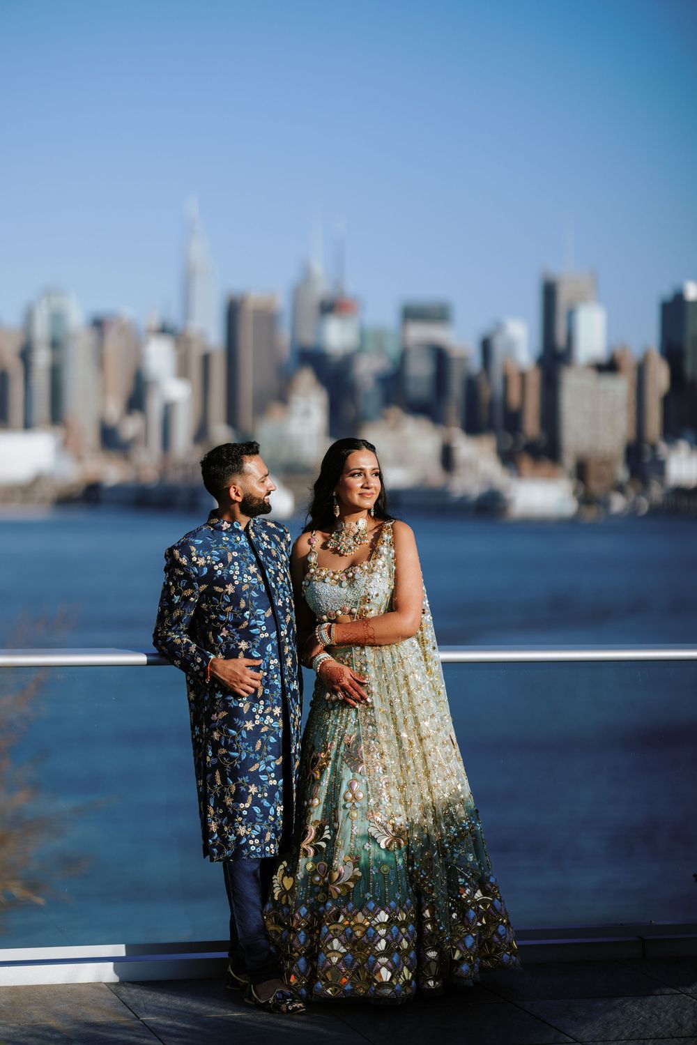 Stunning couple portrait at Port Imperial, Weehawken, NJ with NYC skyline backdrop, perfect for luxury South Asian wedding inspiration.