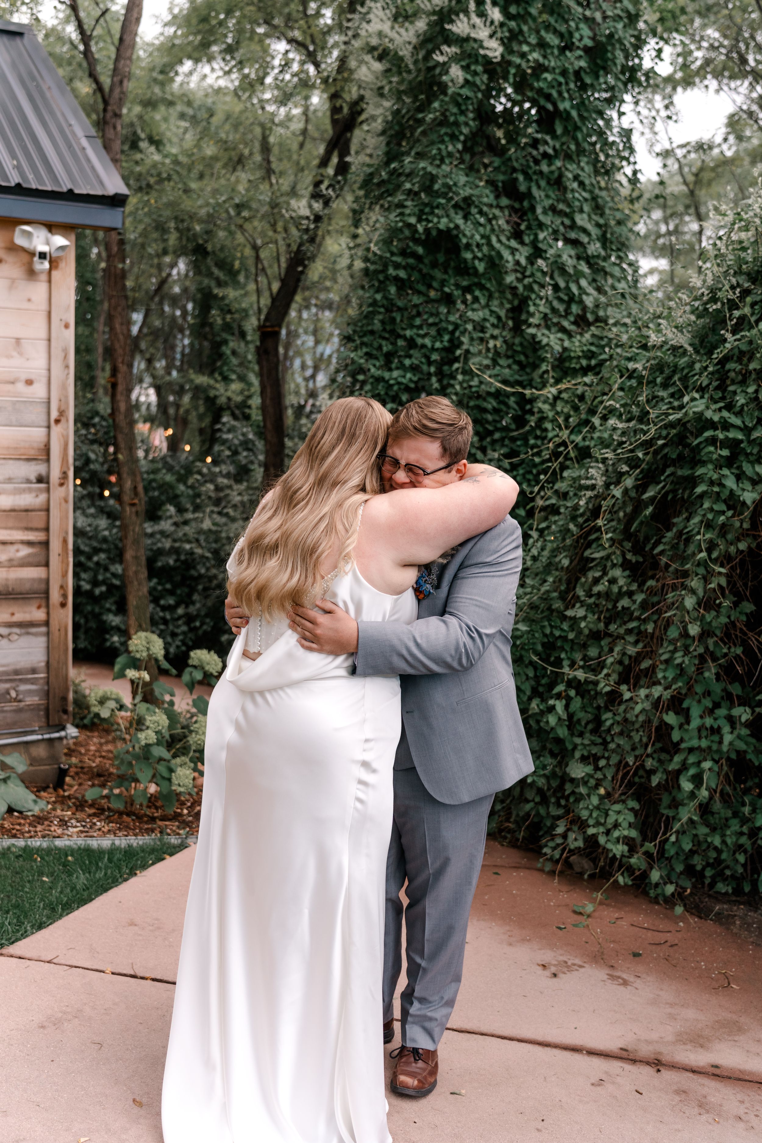 A sequence of romantic first look photos capturing joyful reactions between a couple in an outdoor garden venue.