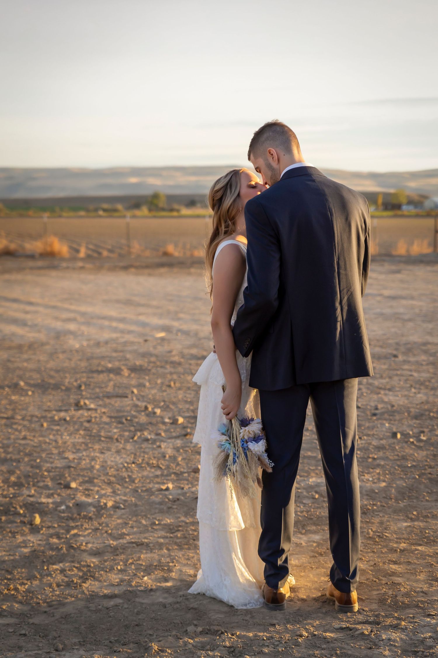bride and groom couples photo in pasture on farm
