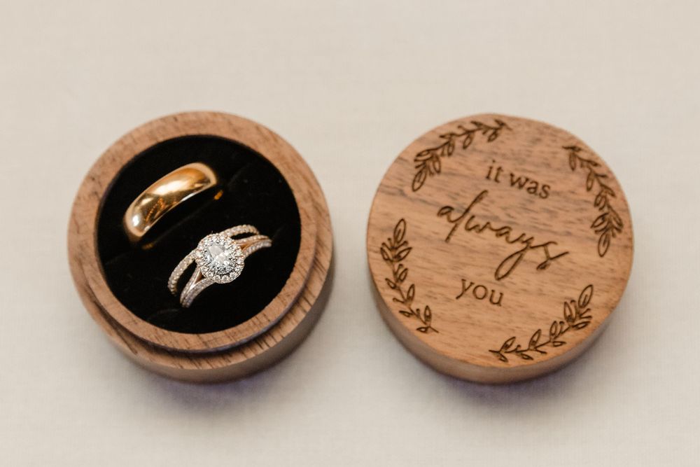 Small wooden decorative ring boxes with hand-painted designs featuring delicate gold and black accents on natural wood.